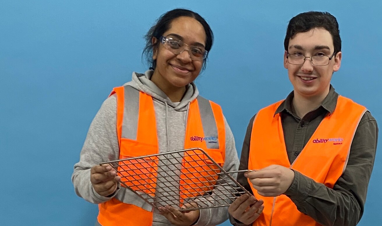 an employee and support team member posing for a photo