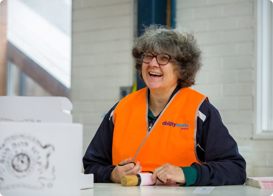 A smiling employee working in packing and assembly