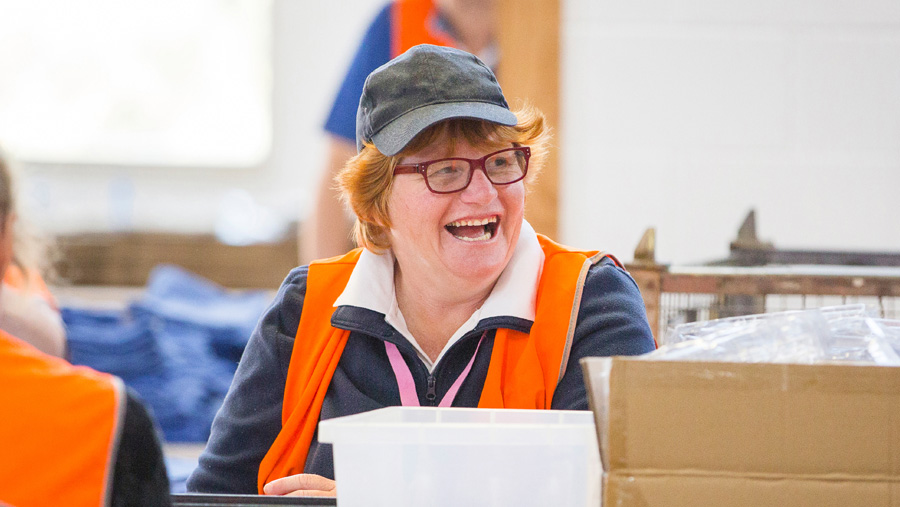a smiling employee in packing and assembly