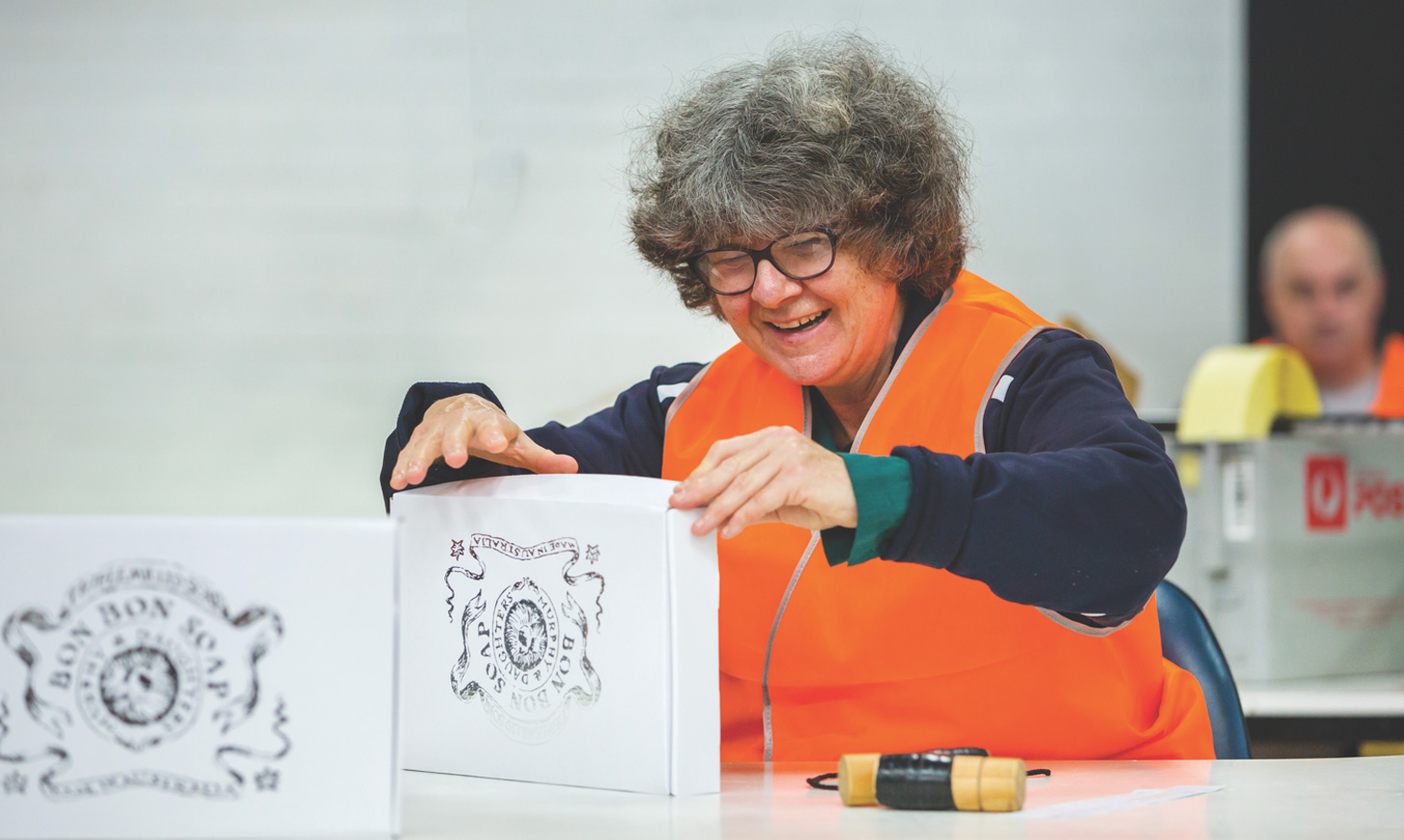 A woman happy about a box she has packed
