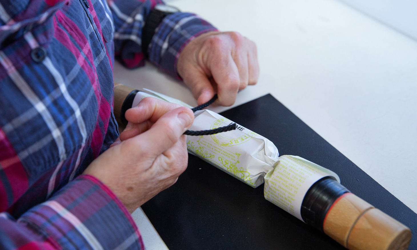 A close up of a bon bon being wrapped