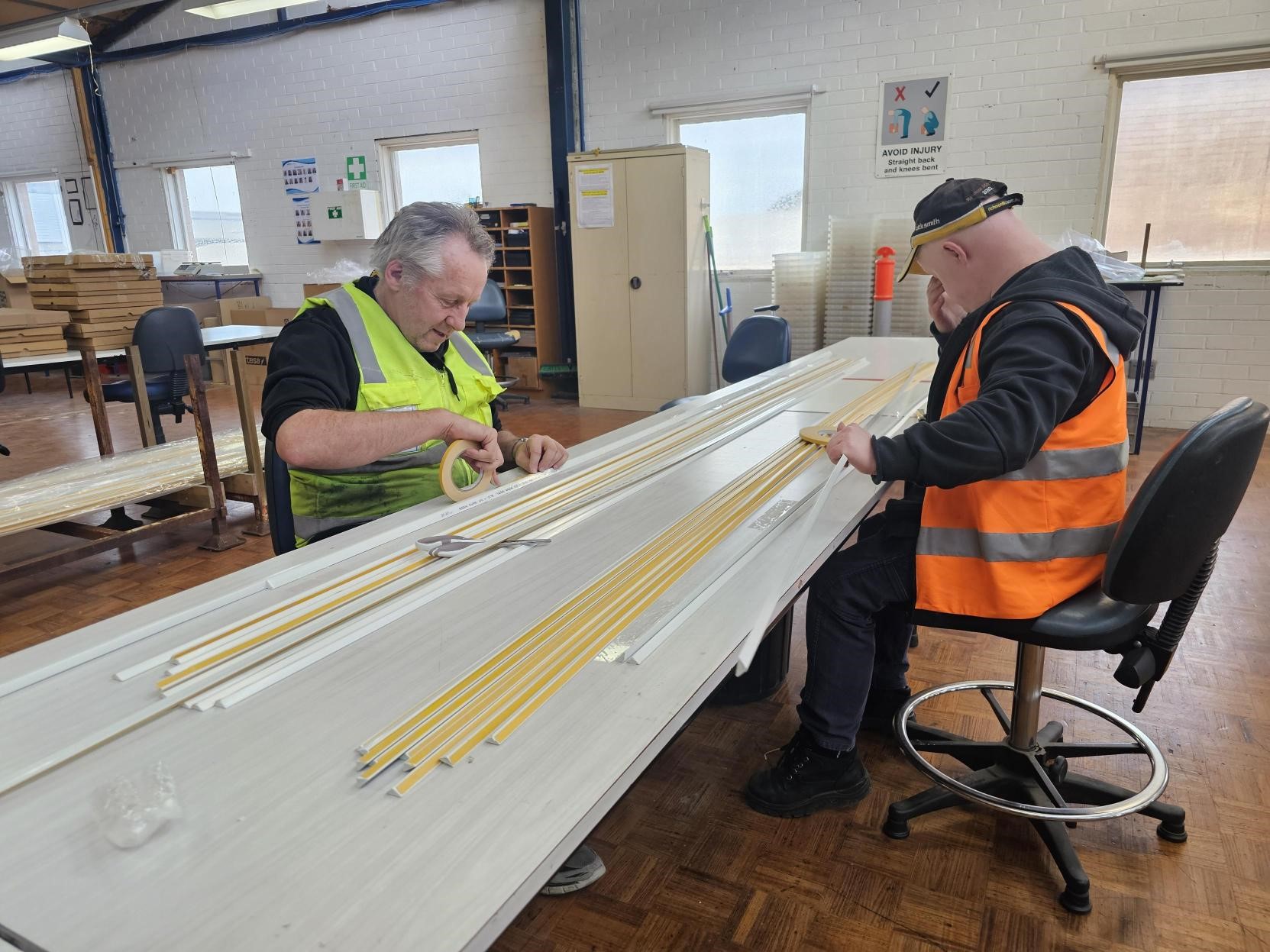 2 employees working in packing and assembly