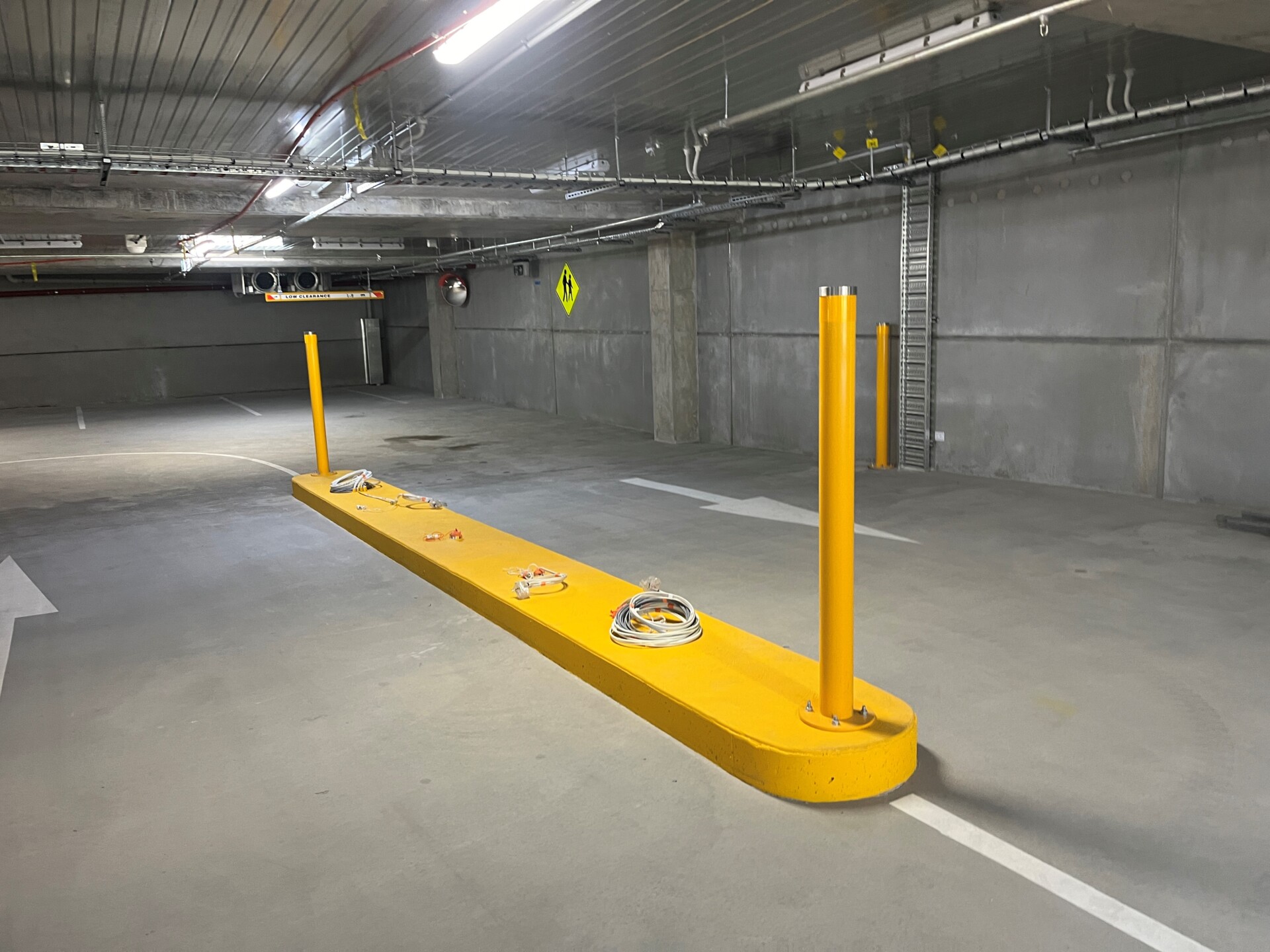 Yellow bollards in an undercover car park
