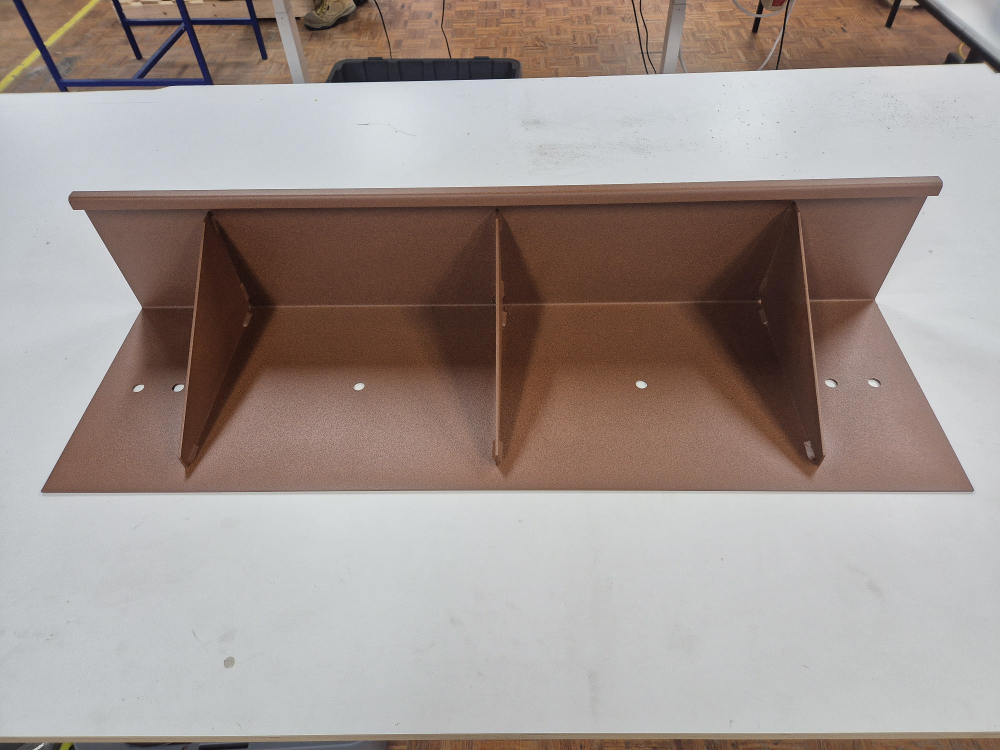 A finished piece of a garden edge laying on table
