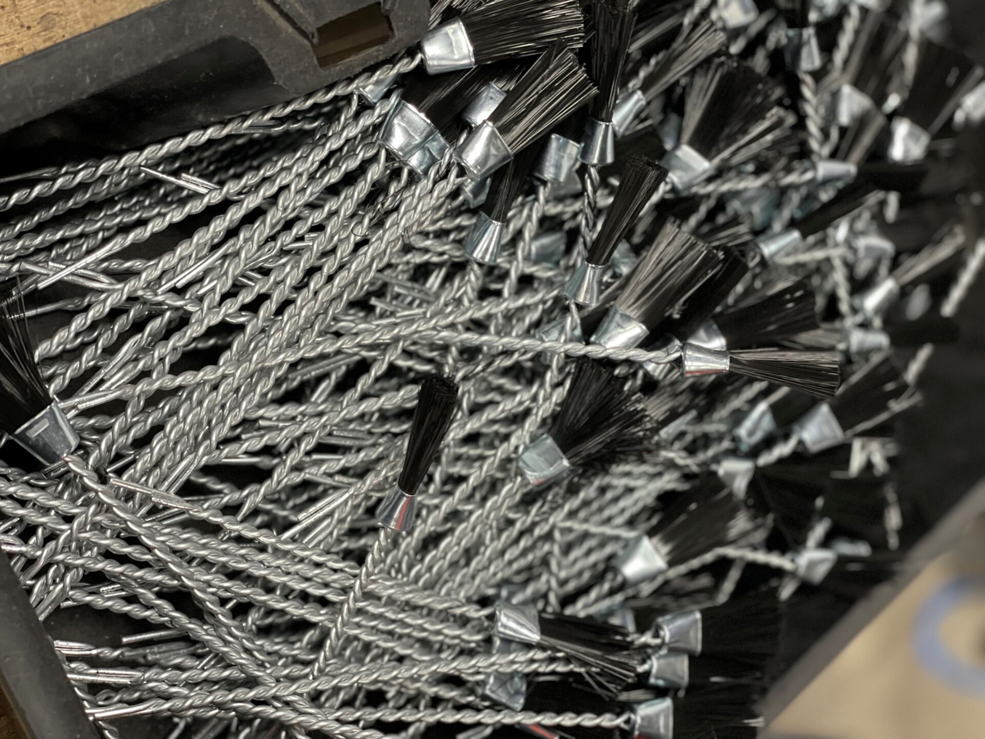 A bunch of wire stemmed brushes in a box