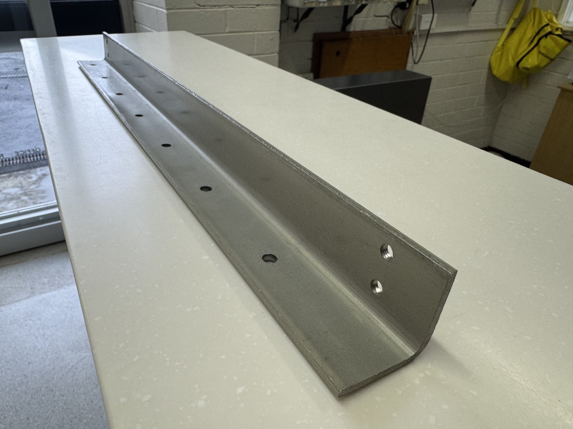 a long gray metal brack laying on a table